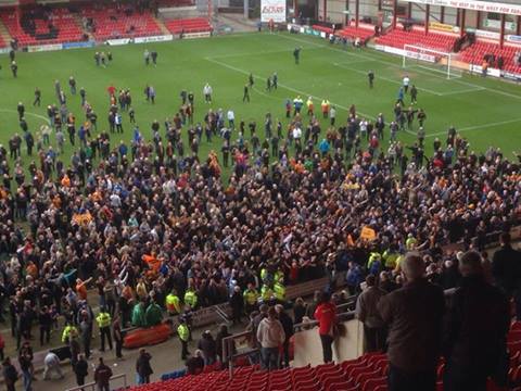 A pitch invasion of the acceptable, friendly kind as Wolves fans celebrate the final whistle at the Alexandra Stadium this afternoon. 